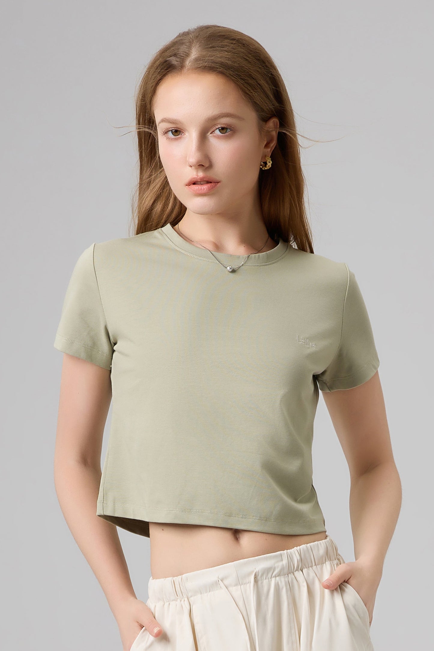 Front portrait of The Lethe Logo Tee in Desert Taupe showing soft cotton fabric and subtle embroidered logo.