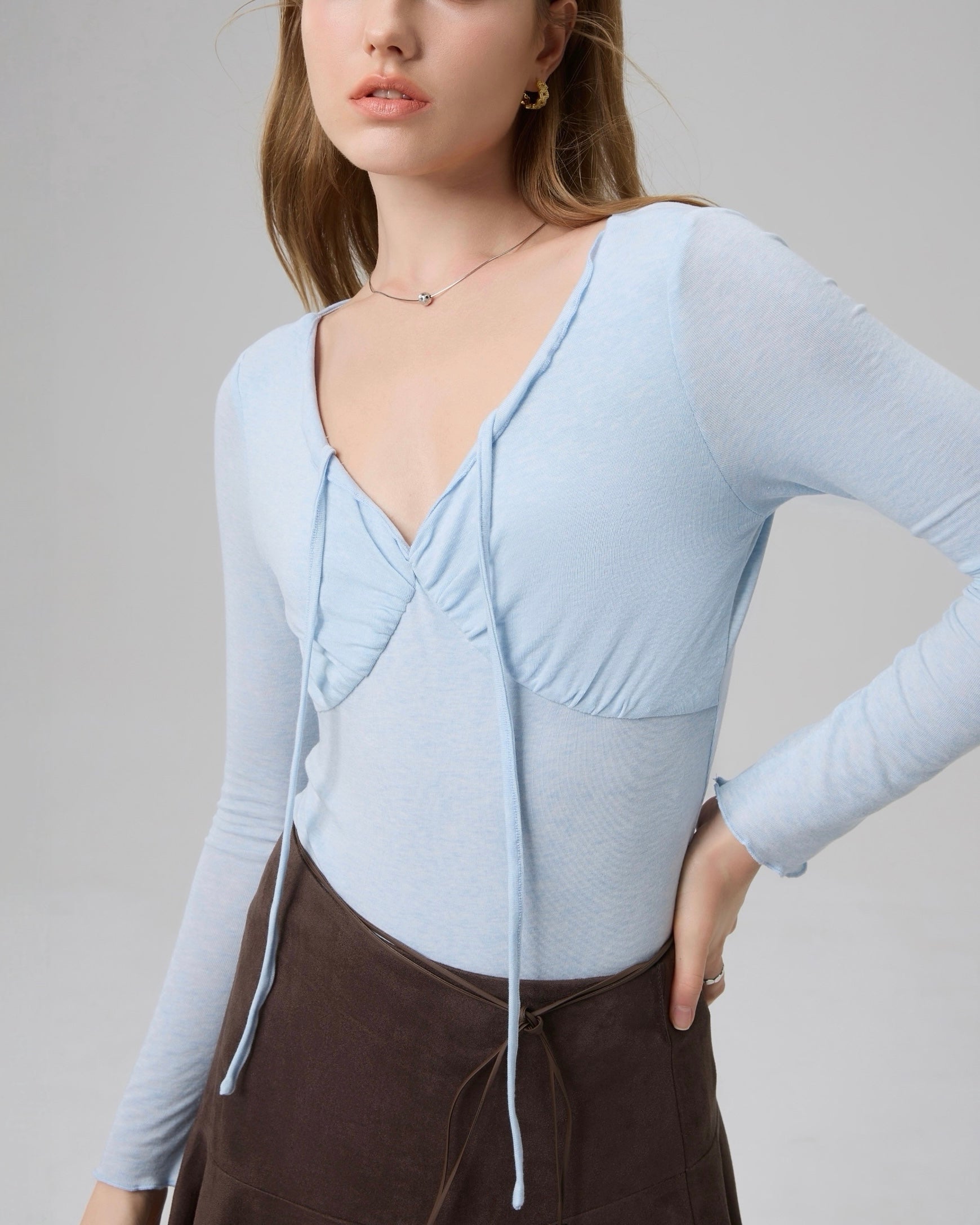 Close-up of The Knit Reverie Flowing Top showing ruched bust detail and delicate knit texture.