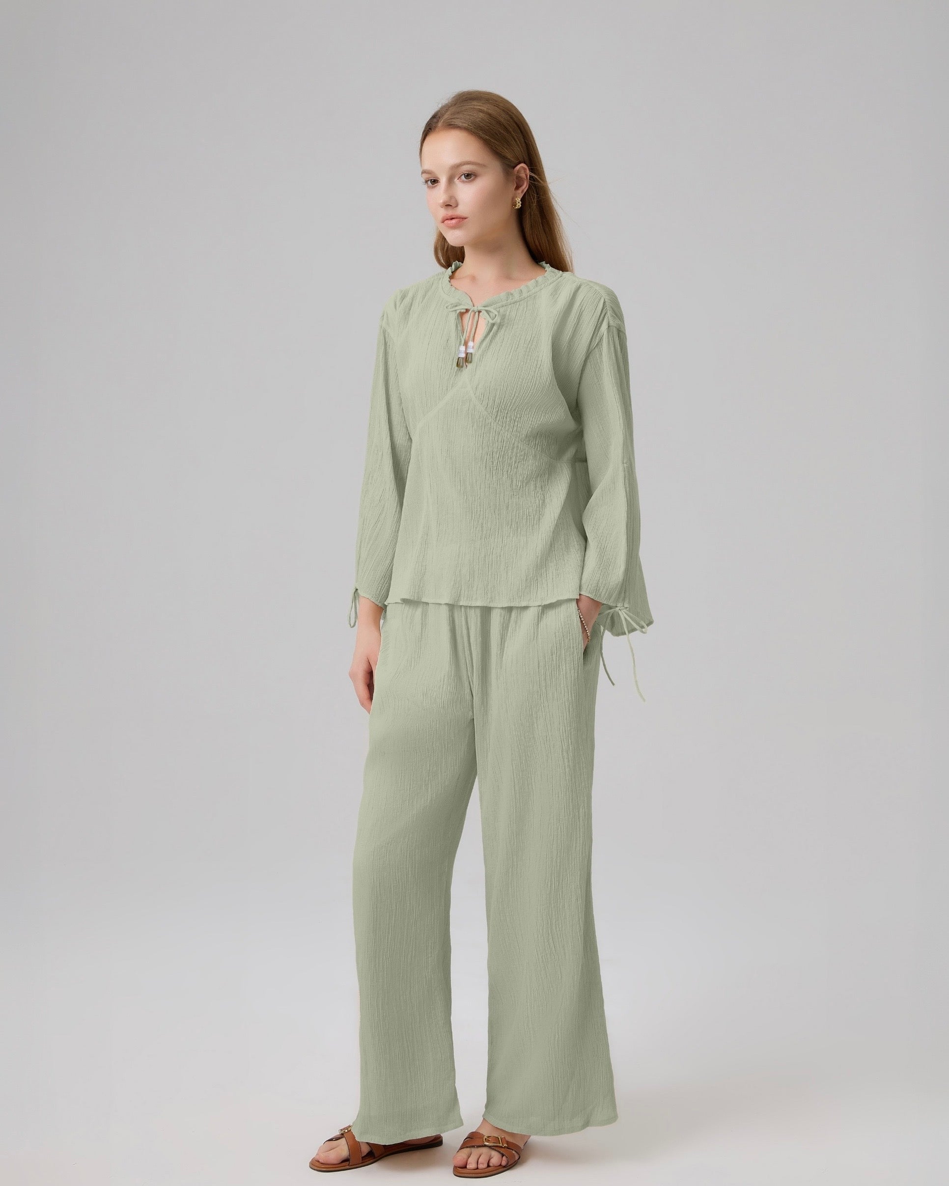 Model wearing Lethe Drift Drawstring Sleeve Blouse in Sage Green, paired with matching Drift Layered Pants