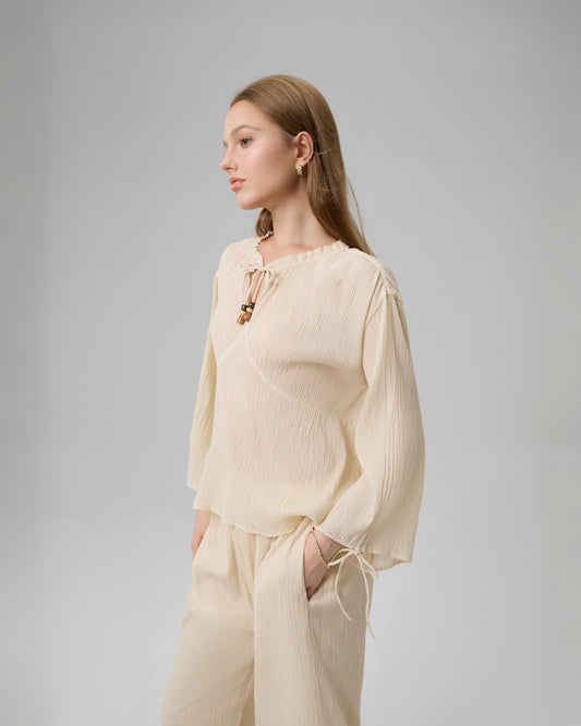 Close-up of tie neckline and adjustable drawstring sleeves with matching beads on Lethe Drift Drawstring Sleeve Blouse